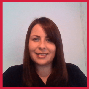A woman with straight brown hair and a black top smiles at the camera, sitting against a plain light-colored background with a red border around the image.